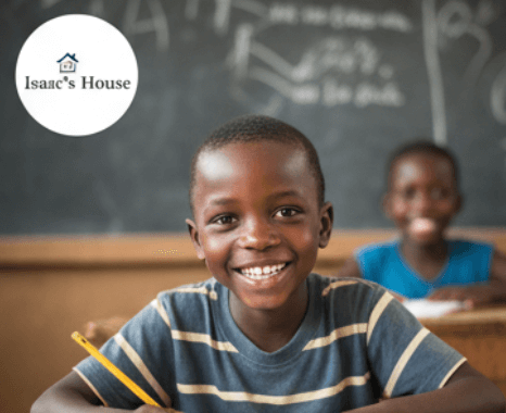 A young Ugandan child focused on their schoolwork, supported by Isaac's House.
