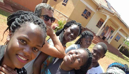 Paul Howells, the founder of Isaac's House, with children in Uganda.